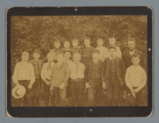 Group portrait of (presumably) a class of a boys' school with a teacher