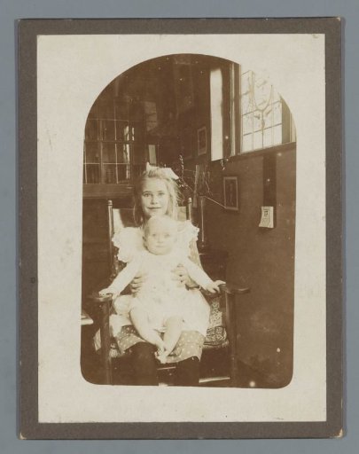 Portrait of an unknown girl with a baby on her lap
