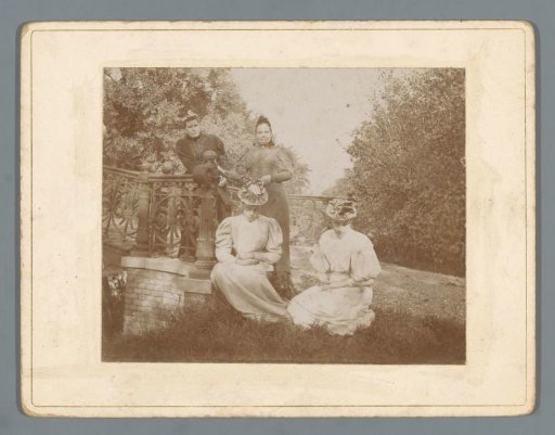 Portrait of four unknown women beside a bridge