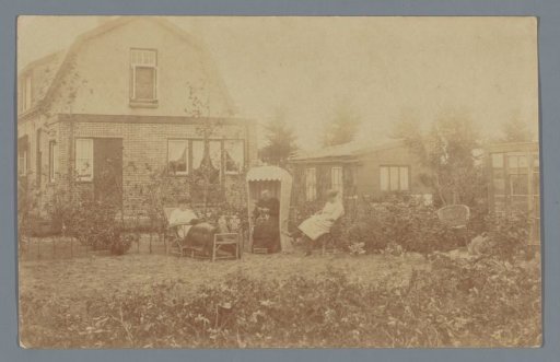 View of a backyard with three unknown women reading