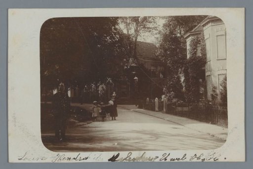 View of a Street with a Man in Uniform and a Woman with Three Children