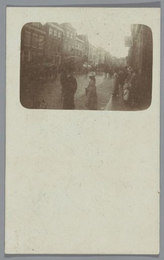 View of a street with (presumably) a funeral procession