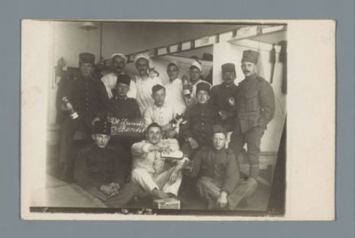 Group portrait of soldiers around a board with the text "The Black Gang"