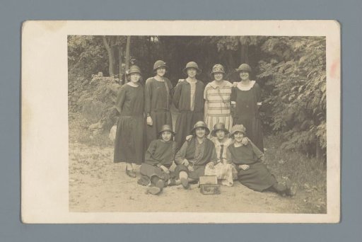Group portrait of nine unknown women on a forest path