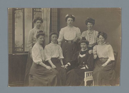 Group portrait of seven unknown women in an interior