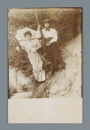 Portrait of two unknown women on a rock wall