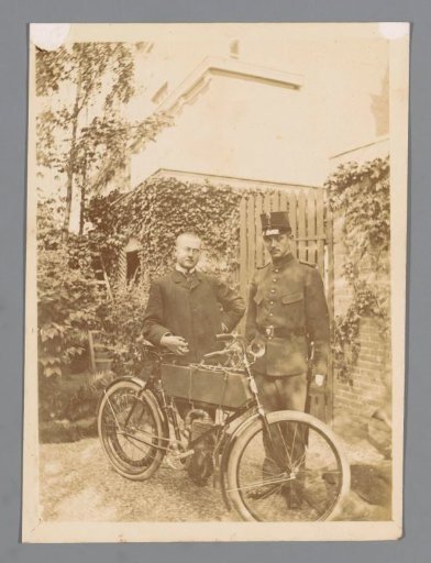 Unknown man and a police officer next to a motorcycle