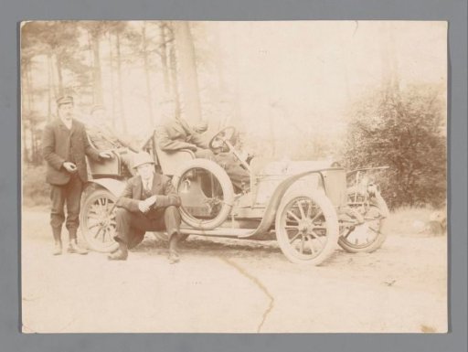 Five unknown men around a car in a forest