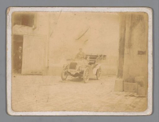 Unknown man in a car in a courtyard