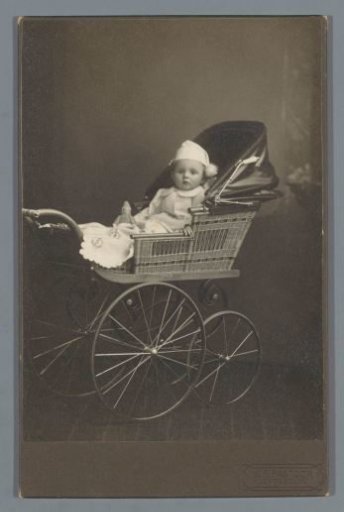 Studio portrait of a baby in a baby carriage