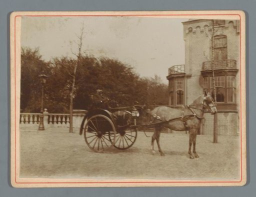 Unknown man in a carriage with a horse in front of a country house