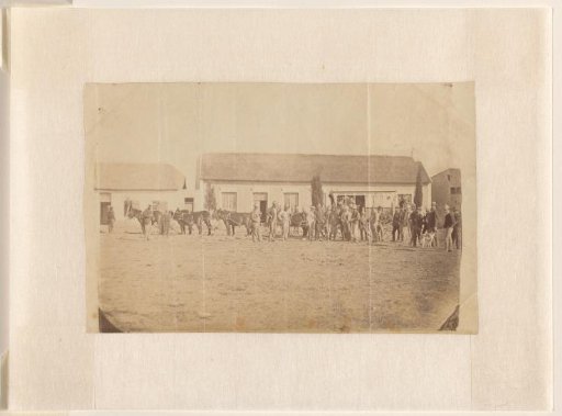 Group of men with horse-drawn carriages, possibly in the United States or South Africa