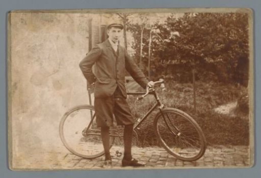 Portrait of an unknown boy with a bicycle