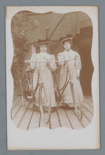 Portrait of two unknown women with bicycles