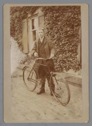 Portrait of an Unknown Man with a Bicycle in Front of a House