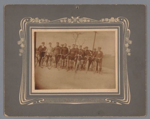 Group portrait of unknown men with bicycles