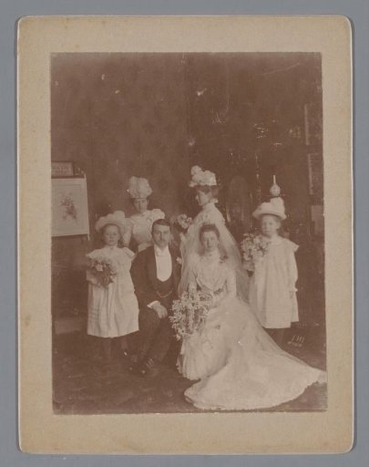 Portrait of an unknown bride and groom with four bridesmaids