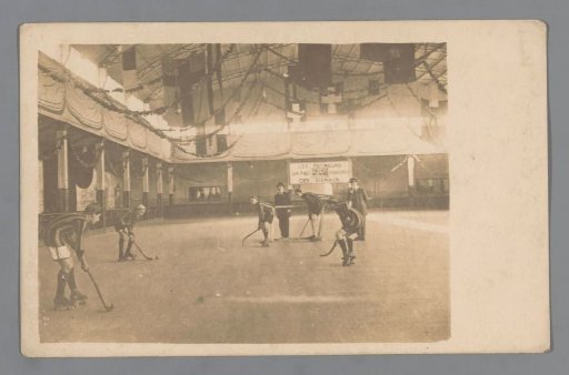 Hockey players on roller skates in a sports hall