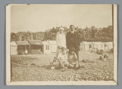 Portrait of an unknown family with two children on a pebble beach