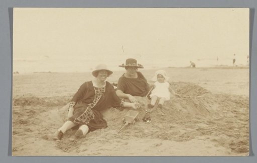 Two women with a child on the beach in Scheveningen