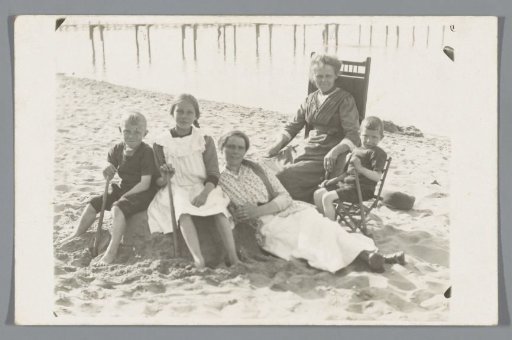 Group portrait of two unknown women and three children on the beach