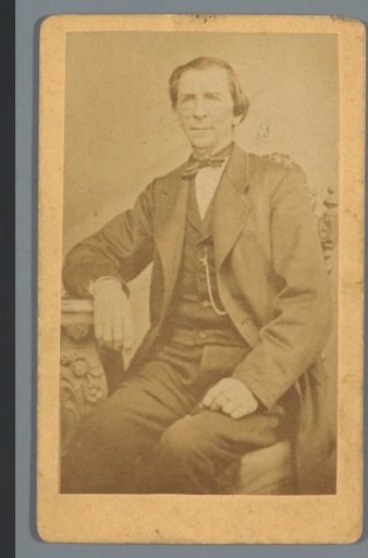 Portrait of an unknown man, seated at a table