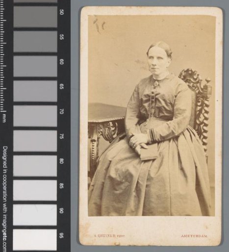 Portrait of an unknown woman, seated at a table with a book in her hand