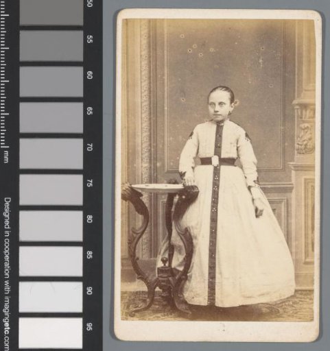 Portrait of an unknown girl, standing next to a table