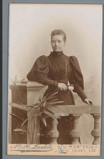 Portrait of an unknown woman, standing by a balustrade