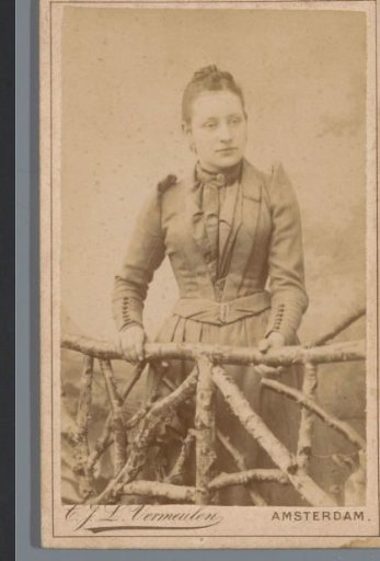 Portrait of an unknown woman, leaning over a fence