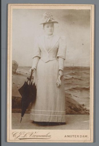 Portrait of an unknown woman with an umbrella and gloves in her hand