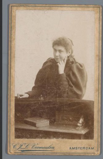 Portrait of an unknown woman, leaning over a desk