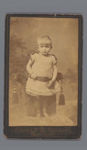 Portrait of an unknown child standing on a chair