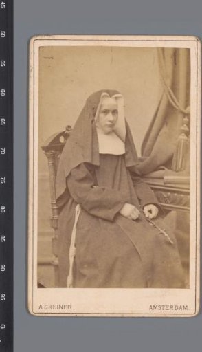 Portrait of an unknown nun, seated at a desk