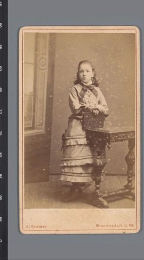 Portrait of an unknown girl, standing beside a table