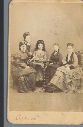 Group portrait of five unknown women around a table