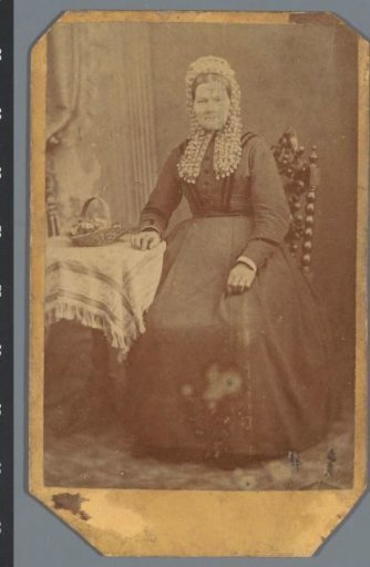 Portrait of an unknown woman at a table