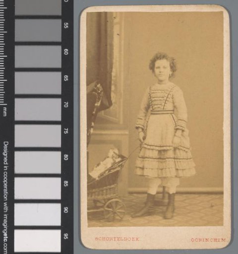 Portrait of an unknown girl with a doll's pram