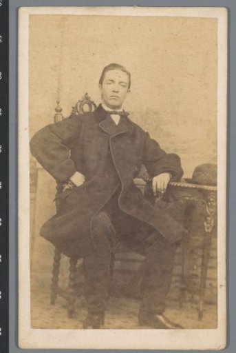 Portrait of an unknown young man at a table