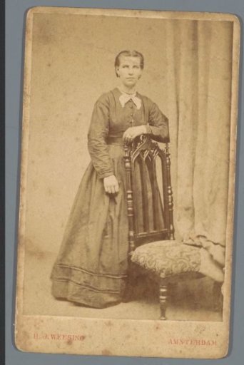 Portrait of an unknown woman by a chair