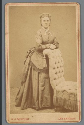 Portrait of an unknown woman by a chair