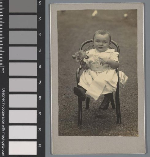 Portrait of an unknown child on a chair