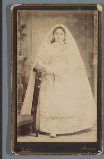 Portrait of an unknown girl in a white dress for her first communion