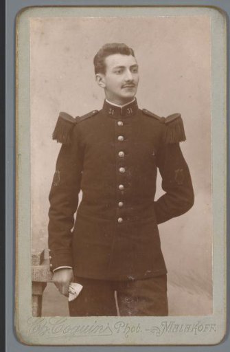 Portrait of an unknown boy with a cap and rifle