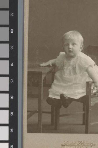 Portrait of an unknown child at a table