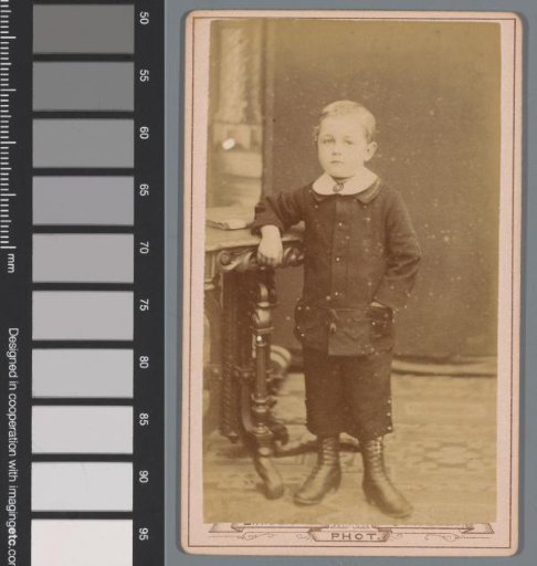 Portrait of an unknown boy at a table