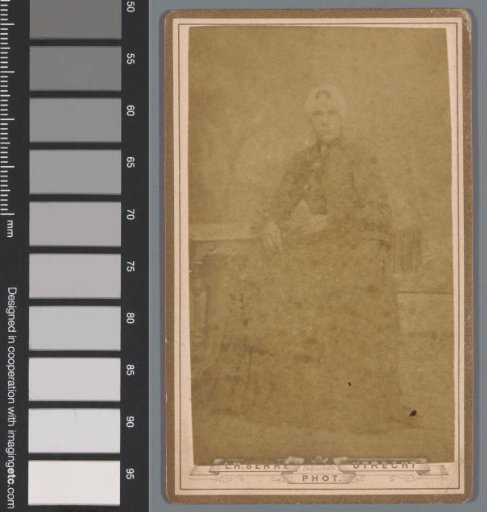 Portrait of an unknown woman at a table