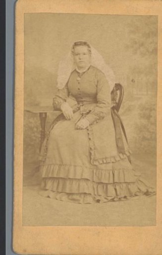 Portrait of an unknown woman at a table