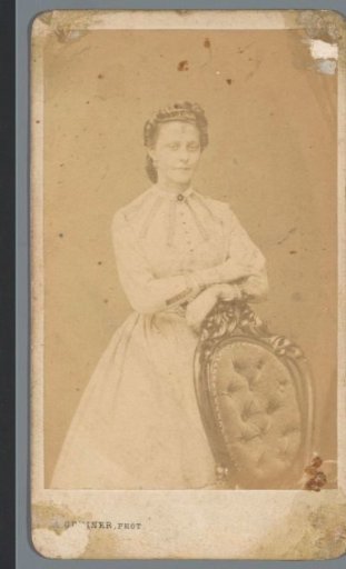 Portrait of an unknown woman behind a chair