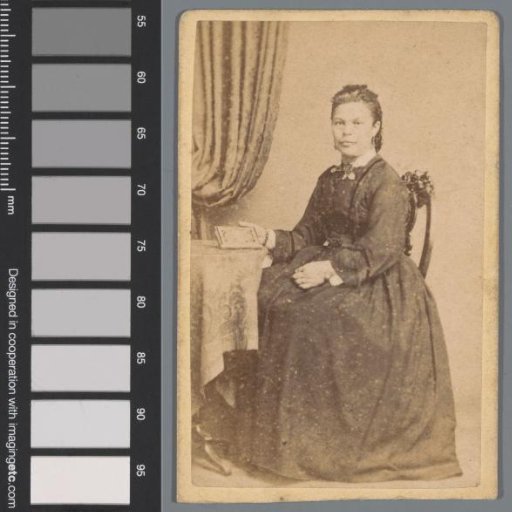 Portrait of an unknown woman with a book at a table
